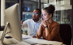 man and woman looking over their project management software